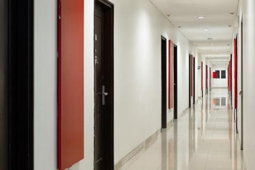 a hallway with a row of paintings on the walls at Amaris Hotel Pemuda Semarang in Semarang