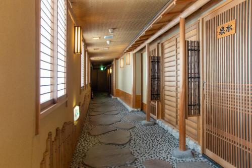a corridor of a building with a walkway at Matsushima Koumura in Matsushima