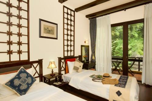 Giường trong phòng chung tại Mai Chau Lodge