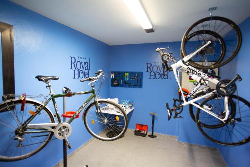 two bikes on a blue wall in a room at Hotel Royal in Fermo