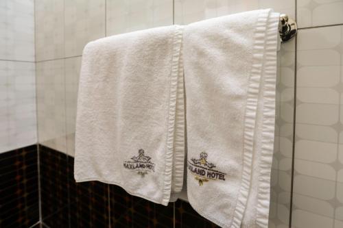 a white towel with the harry potter logo on it at Maxland Hotel in Nairobi