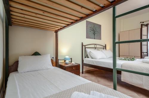 A bed or beds in a room at Theonis Villas