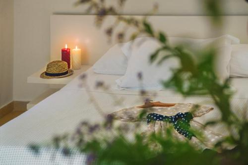 a bedroom with a bed with a candle and a table at Nereids Apartments in Sitia