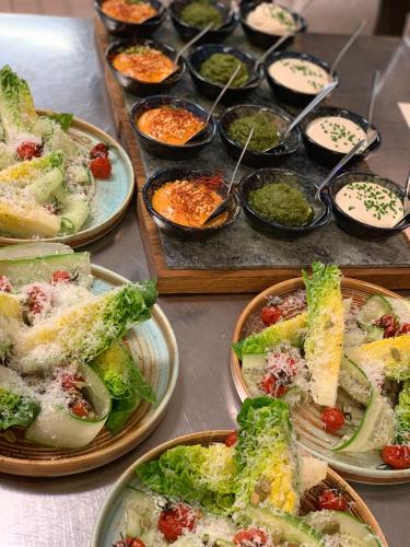 a table with plates of food and bowls of dips at Hotell Karolinen Åre in Åre
