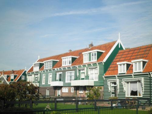 a row of houses with red and green roofs at B&B HutSpot in Amsterdam