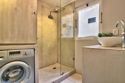 a bathroom with a washing machine and a sink at The Beach Loft in Hout Bay