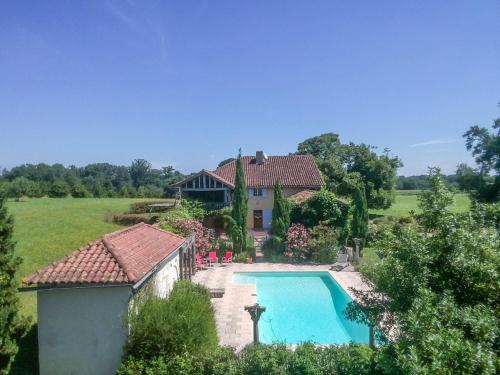 an aerial view of a house with a swimming pool at Beautiful farmhouse with private pool in Le Houga