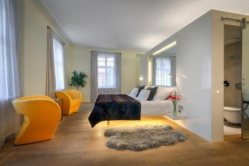 a living room with a couch and a table at Three Storks in Prague