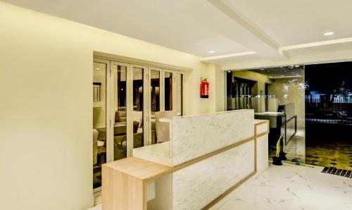 a lobby with a marble counter and a table at Itsy By Treebo - Mirra in Chennai