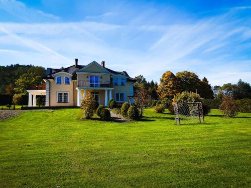 a house with a soccer ball in the yard at Willa Kamieniec in Polańczyk