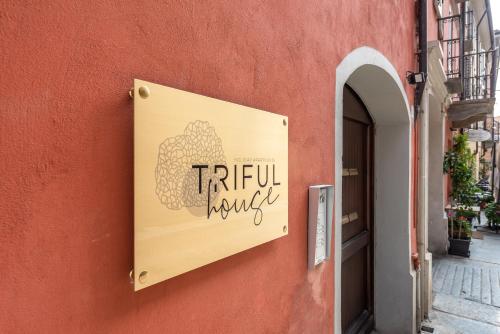 a sign on the side of a building at trifulhouse holiday apartments in Alba