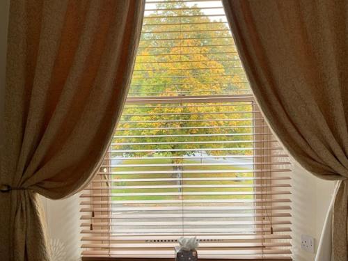 ein großes Fenster mit Vorhängen in einem Zimmer in der Unterkunft Alexandra Hotel in Ballater