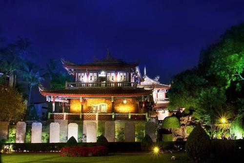 a chinese building at night with lights at Temple Side Hostel in Tainan