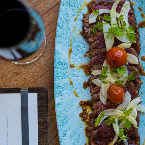 a plate of food with meat and vegetables on a table at PoMo Hôtel & Restaurant in Échirolles