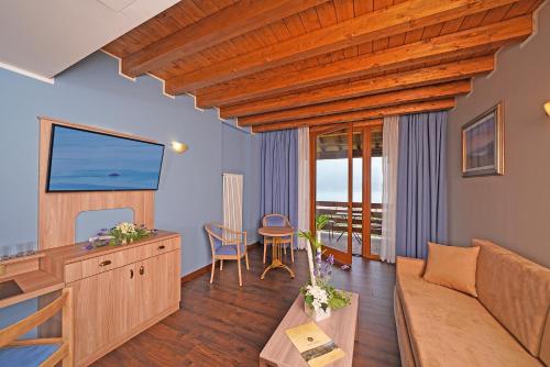 a living room with a couch and a table at Hotel Caravel in Limone sul Garda