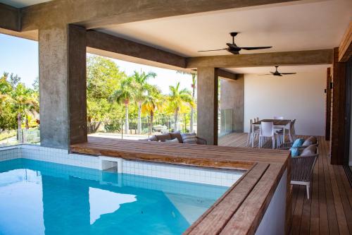 a house with a swimming pool and a patio at Manta Cove by Horizon Holidays in Tamarin