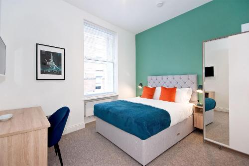 a bedroom with a large bed and a mirror at Interlude House A by City Living London in London