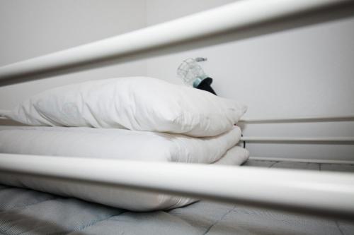 a stack of pillows on a bed in a room at City Backpackers Hostel in Stockholm