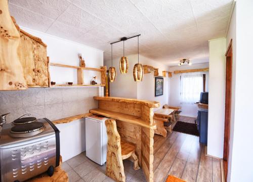 a kitchen with a table and a stove at Etno selo Moj Zavičaj in Gornji Milanovac