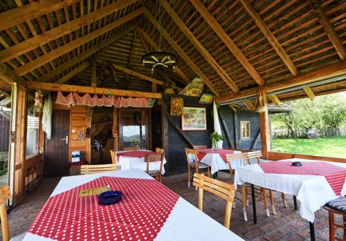a dining room with tables and chairs in a pavilion at Etno selo Moj Zavičaj in Gornji Milanovac