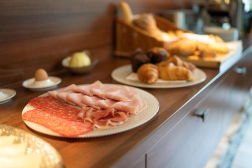 a counter with plates of food on top at Hotel Anna in Beroun