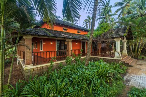 a house in the middle of a garden at SaffronStays Blue Flag House, a 3-BDR beachfront villa in Hejamady in Mangalore