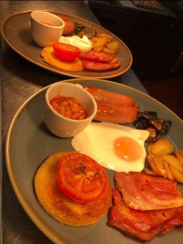two plates of breakfast food on a table at Twin Oaks Hotel in Chesterfield