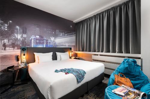 a bedroom with a large bed and a large window at Three Corners Hotel Anna in Budapest