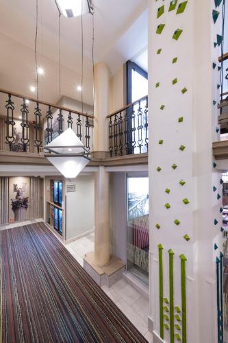 an empty lobby with a large rug on the wall at Three Corners Hotel Art in Budapest