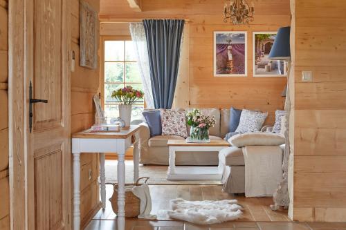 a living room with a couch and a table at Osada Maruszyna in Szaflary