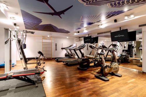 a gym with several treadmills and elliptical machines at Novotel Warszawa Airport in Warsaw