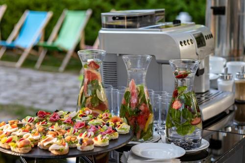 a table with two plates of food and two vases at Novotel Warszawa Airport in Warsaw