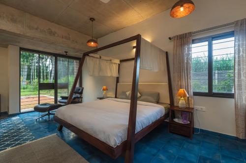 A bed or beds in a room at SaffronStays Riverstone, Mysuru