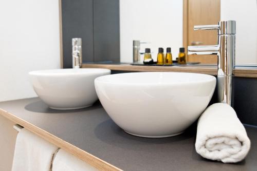 a bathroom with two white bowls on a counter at Alpengasthof Hotel Schwand in Oberstdorf