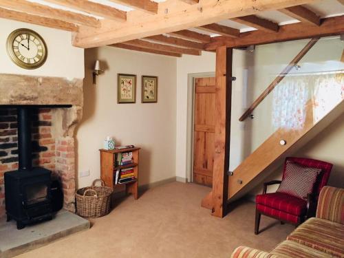 a living room with a fireplace and a clock on the wall at 75 High Street in Melbourne