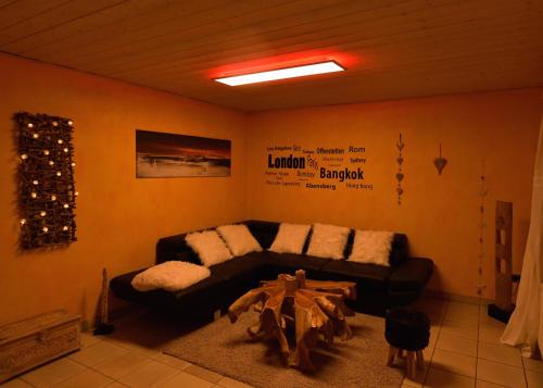 a living room with a couch and a table at Ferienwohnungen Eisler in Abensberg