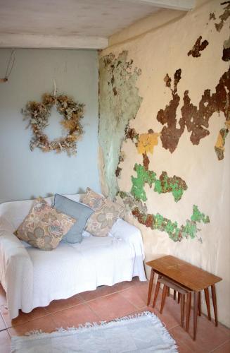 a living room with a white couch and a wall at Bethany Farm in Twee Riviere