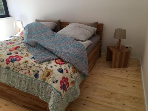 a bedroom with a bed with a blanket on it at Eifelhaus UT Mutscheid in Bad Münstereifel