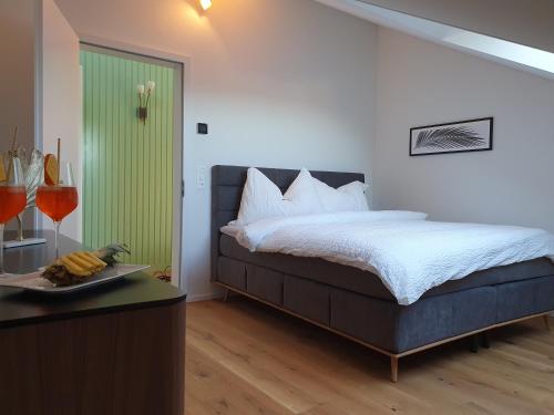 a bedroom with a bed and a table with a plate of food at Wohnstation President Suite in Subingen