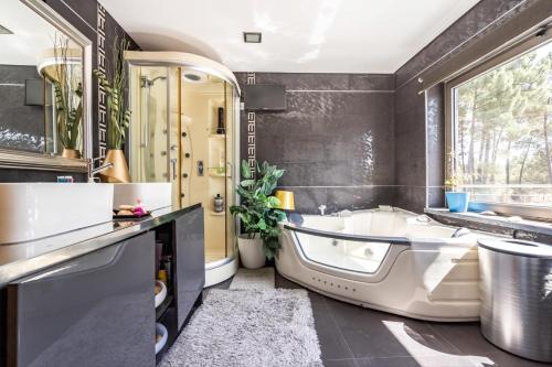 a bathroom with a tub and a sink at Akivillas Azeitao Relax in Azeitao