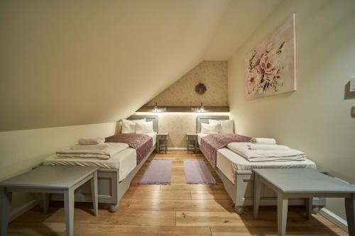 a room with two beds in a attic at Takler Kúria in Szekszárd