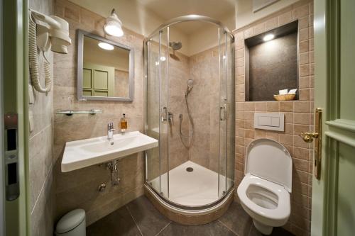 a bathroom with a shower and a toilet and a sink at Takler Kúria in Szekszárd