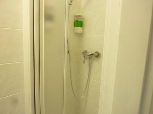 a shower with a shower head in a bathroom at Apartmán VAN NG in Prague