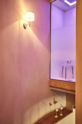 a bathroom with a mirror and a sink at Il Torrino - Deb'S Monticchiello in Pienza