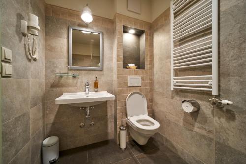 a bathroom with a toilet and a sink at Takler Kúria in Szekszárd