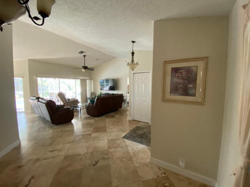a living room with a couch and a table at Modern Pool Home in Spring Hill