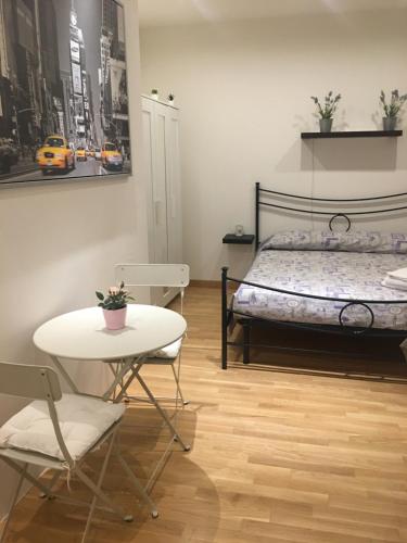 a bedroom with a bed and a table and chairs at Lulù in Impruneta