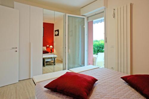Un dormitorio con una cama con almohadas rojas. en Lo Zione, en Arcola