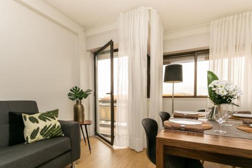 a living room with a couch and a table at APOSENTUS - Elegant Functionality Porto Downtown in Porto