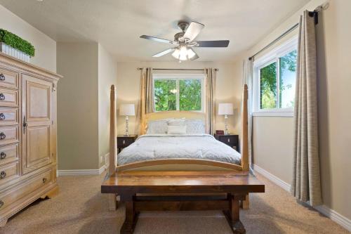 a bedroom with a bed and a ceiling fan at 5 Bedroom Perfect Location to see the City and Ski Resorts in Salt Lake City